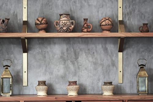 a bunch of vases on shelves in a room at Hotel Casa Hormiga in Bacalar