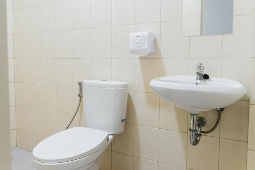 a bathroom with a toilet and a sink at Social Hub by TwoSpaces in Jakarta