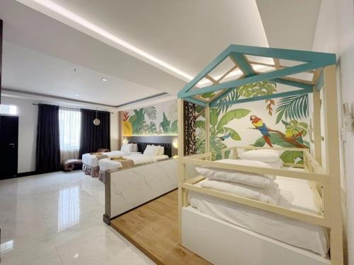a bedroom with two beds and a mural on the wall at Batam Harbour Boutique Hotel & Spa in Nagoya