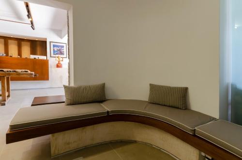 a couch sitting in a living room next to a wall at Sarikampos Beach in Myrtos