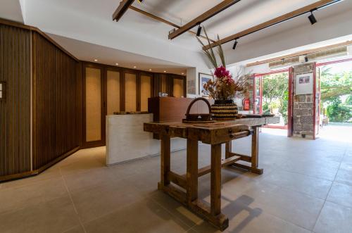 a kitchen with a wooden table in a room at Sarikampos Beach in Myrtos