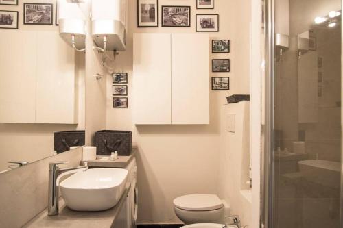 a white bathroom with a toilet and a sink at YouHosty - Arnaboldi 15 in Milan