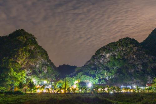 a view of a group of mountains at night at Green Mountain Homestay in Ninh Binh
