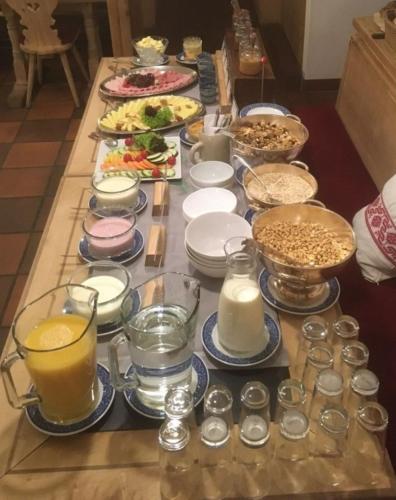 a table with many plates and bowls of food at Hotel Wynegg in Klosters