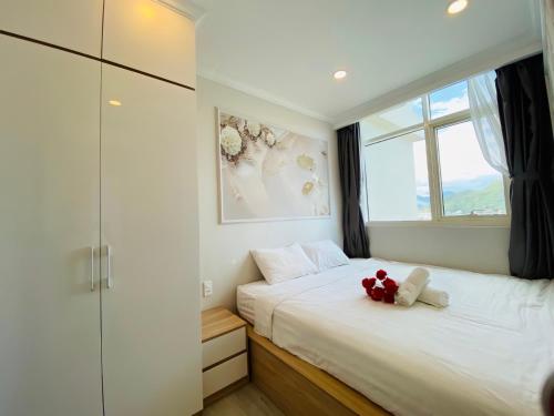 a bedroom with a bed with a teddy bear on it at NHA TRANG COMFORTZONE APARTMENT in Nha Trang