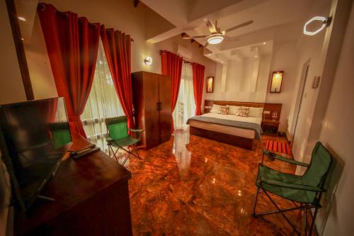a bedroom with a bed and some chairs in it at Y&Y Residence in Kandy