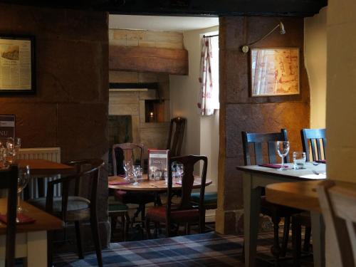 a dining room with tables and chairs in a restaurant at The Masons Arms in Yeovil