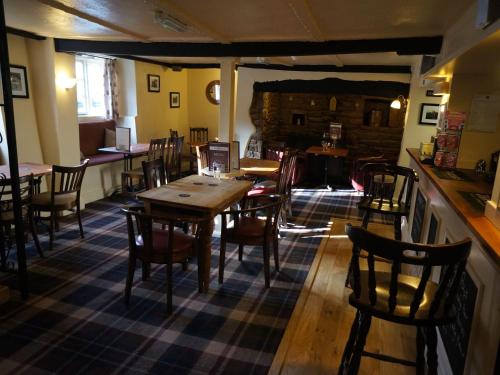 a dining room with tables and chairs in a restaurant at The Masons Arms in Yeovil