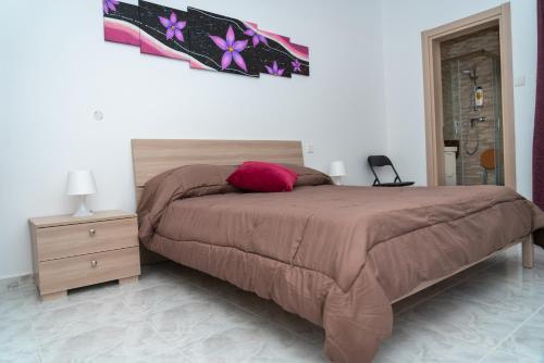 a bedroom with a bed with a brown comforter at Sea-View 3 bedroom Apartment - Sleeps 8 in Marsaskala