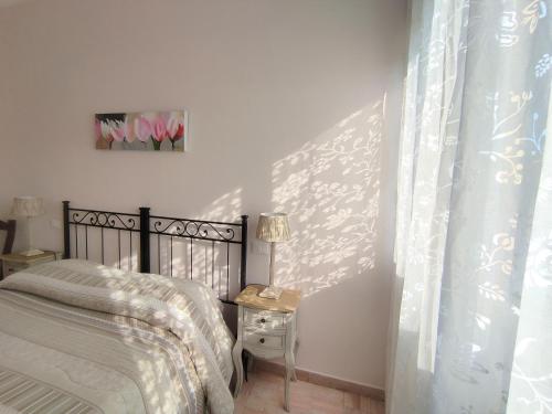 a bedroom with a bed and a table with a lamp at La Mimosa Chic in Pietrasanta