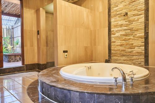 a large bathroom with a tub in a room at Dongfeng Motel in Guishan