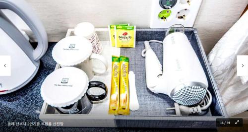 a suitcase with various kitchen items in it at The Stay Century Hotel in Jeju