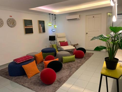 a living room with colorful chairs and a couch at MyBed Homestay in Padang Besar