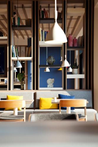 a living room with a couch and tables and shelves at Holiday Inn Express - Offenburg by IHG in Offenburg