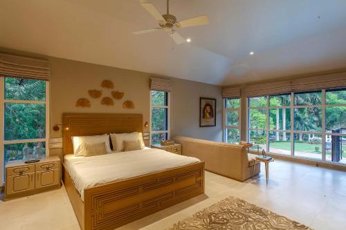A bed or beds in a room at StayVista at Ananta