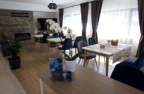 a living room with tables and chairs and a dining room at MIRA by Atra in Teşila