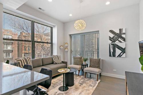a living room with a couch and a table at Cozy & Modern 3BR Apartment - Division 201W 301W REP in Chicago