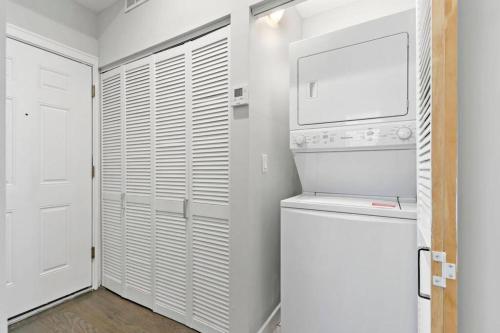 a white laundry room with a washer and dryer at Cozy & Modern 3BR Apartment - Division 201W 301W REP in Chicago