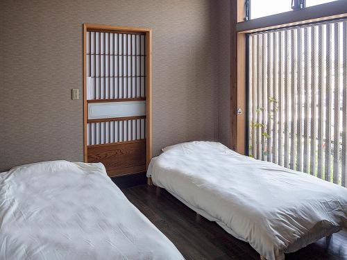 Postel nebo postele na pokoji v ubytování HOSTEL Co-EDO