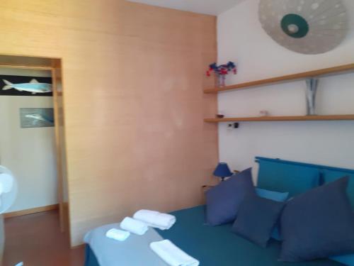 a room with a blue couch and a table at Affittacamere Da Luca in Bonassola