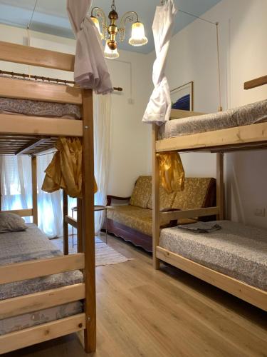 a room with three bunk beds in a hostel at The Wanderers Hostel in Shkodër