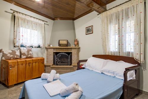 a bedroom with a bed and a fireplace at Konstas Stone Island House in Meganisi in Meganisi