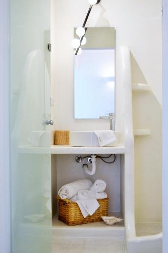 a bathroom with a sink and a mirror at Krotiri View Paros in Krotiri