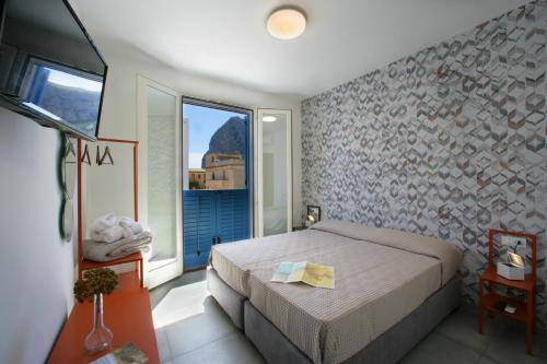 a bedroom with a bed and a large window at ITACA e MEDEA - Appartamenti con idromassaggio in terrazza in San Vito lo Capo