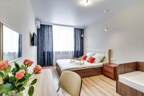 um quarto de hotel com uma cama e uma secretária em Апартаменты на Лермонтовской и Гвардейском em Rostov on Don