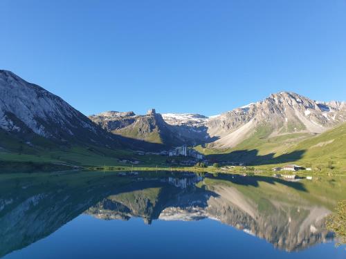 a reflection of a mountain in a lake at Le Terril Blanc in Tignes