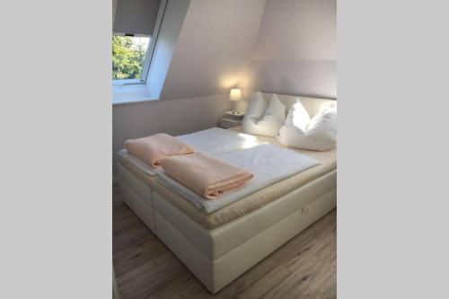 Ένα ή περισσότερα κρεβάτια σε δωμάτιο στο Ferienwohnung Herzmuschel