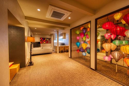 a hallway with a room with colorful lanterns on the wall at ADAN RESORT 灯 - Lamp - in Motobu