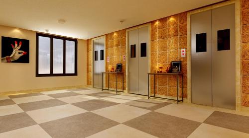 a lobby with a checkered floor and a window at Lemon Tree Premier, Bhubaneswar in Bhubaneshwar