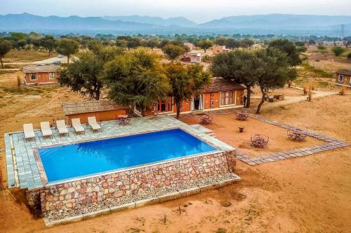 an aerial view of a house with a swimming pool at Camp Lands End in Pushkar