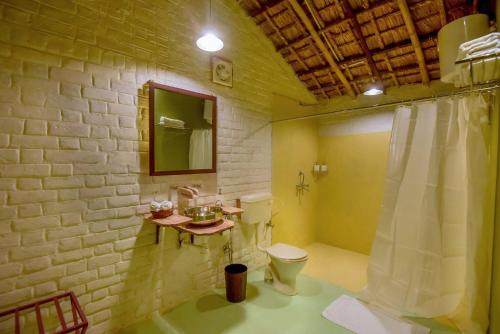 a bathroom with a toilet and a sink at Camp Lands End in Pushkar