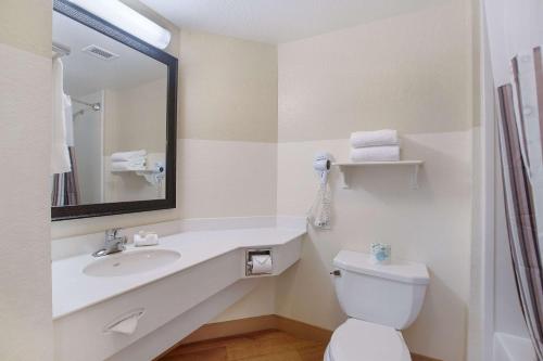 a bathroom with a sink and a toilet and a mirror at La Quinta by Wyndham Ft. Lauderdale Airport in Hollywood