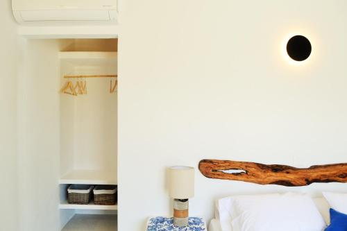 a room with a bed and a log on the wall at Krotiri View Paros in Krotiri