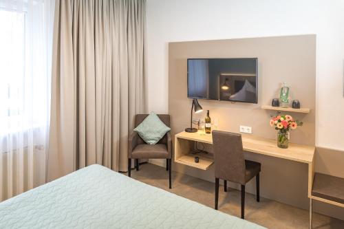 Ένα ή περισσότερα κρεβάτια σε δωμάτιο στο Hotel Lehn