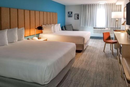 a hotel room with two beds and a desk at Hotel Thea Tacoma, Ascend Hotel Collection in Tacoma