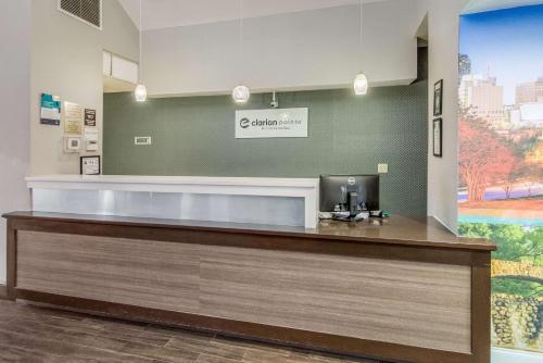 a lobby with a reception desk in a building at Clarion Pointe Wake Forest – Raleigh North in Wake Forest