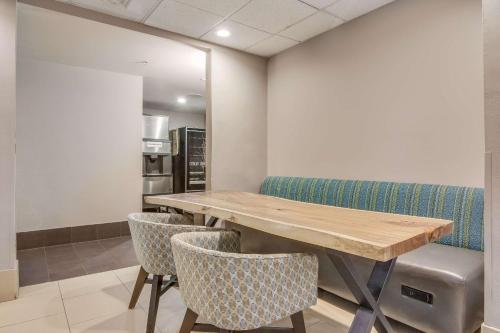 a conference room with a wooden table and chairs at Clarion Pointe Wake Forest - Raleigh North in Wake Forest