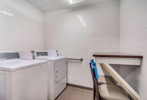 a laundry room with a washer and dryer at Clarion Pointe Wake Forest - Raleigh North in Wake Forest