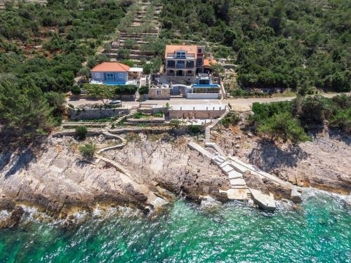 an aerial view of a house on a cliff next to the water at Holiday Home Dona Maria in Prigradica
