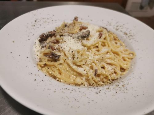 a white plate of pasta with seasoning on a table at Hotel L'Escala in Cullera