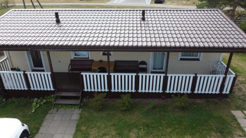an overhead view of a house with a white fence at Rooms for Rent near Vilnius in Bezdonys