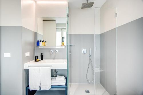 a bathroom with a sink, toilet, and shower at Victor Boutique Hotel in Milan