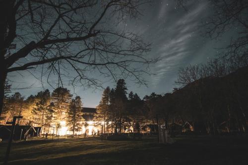 a building lit up at night in a park at Te'Dreri - Llogora Tourist Village in Dhërmi