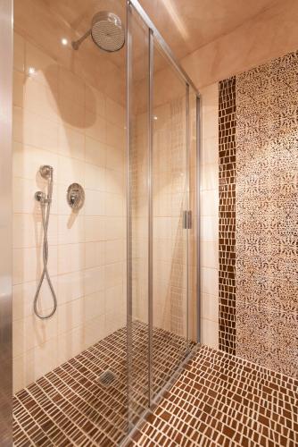 a shower with a glass door in a bathroom at Villa Rosmarino in Imperia