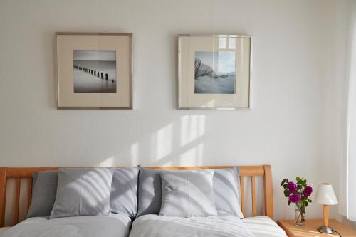um quarto com duas fotografias na parede e uma cama em Am Haff Rerik em Rerik