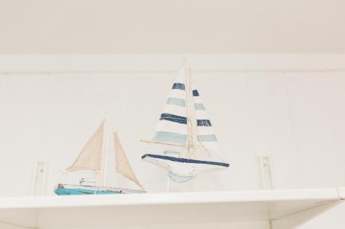 a shelf with three miniature boats on it at Sea View Snugs at Laggan in Gatehouse of Fleet